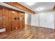 A cozy basement with wood-paneled walls, lighting, and plenty of storage at 3624 Moultrie St, Charlotte, NC 28209
