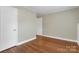 This bedroom has hardwood floors, neutral paint, and two closets at 3624 Moultrie St, Charlotte, NC 28209