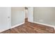 Bedroom featuring laminate floors, neutral walls, and white trim at 3624 Moultrie St, Charlotte, NC 28209