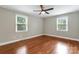 Spacious bedroom with hardwood floors, neutral walls, and a ceiling fan at 3624 Moultrie St, Charlotte, NC 28209