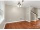 Bright dining room featuring hardwood floors, white trim, and a unique light fixture at 3624 Moultrie St, Charlotte, NC 28209