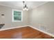 Bright dining area featuring hardwood floors, neutral paint, and an ornate light fixture at 3624 Moultrie St, Charlotte, NC 28209