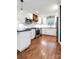 Modern kitchen with white cabinets, stainless steel appliances, and dark countertops at 3624 Moultrie St, Charlotte, NC 28209