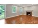 Bright living room boasts hardwood floors, a cozy fireplace, and large windows at 3624 Moultrie St, Charlotte, NC 28209