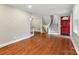 Open-concept living area with hardwood floors, staircase, and view of the front door at 3624 Moultrie St, Charlotte, NC 28209