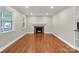 Inviting living room featuring hardwood floors, a fireplace, and recessed lighting at 3624 Moultrie St, Charlotte, NC 28209