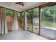Cozy screened porch with neutral curtains and view of backyard at 3624 Moultrie St, Charlotte, NC 28209