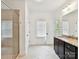 Bright bathroom features walk-in shower, neutral tile, dark cabinets, and granite counters at 4732 Water Oak Rd, Charlotte, NC 28211