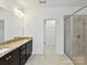 Modern bathroom with double vanity, granite countertop, walk-in shower, and neutral color scheme at 4732 Water Oak Rd, Charlotte, NC 28211