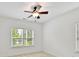 Bright bedroom with large window, neutral carpet, and ceiling fan provides a cozy and relaxing space at 4732 Water Oak Rd, Charlotte, NC 28211