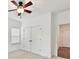This bedroom offers ample storage with closet space, complemented by a window and ceiling fan at 4732 Water Oak Rd, Charlotte, NC 28211
