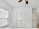 This bedroom offers ample storage with closet space, complemented by a window and ceiling fan at 4732 Water Oak Rd, Charlotte, NC 28211