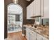 This butler's pantry offers granite countertops, a mirrored backsplash, and a clear view into the dining room at 4732 Water Oak Rd, Charlotte, NC 28211