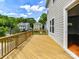 View of a wooden deck with a railing and open door, overlooking neighborhood houses at 4732 Water Oak Rd, Charlotte, NC 28211