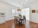 Sunlit dining area with hardwood floors, white walls, and a view into the kitchen at 4732 Water Oak Rd, Charlotte, NC 28211