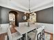 Stylish dining room with elegant chandelier, comfortable seating for six, and arched doorways at 4732 Water Oak Rd, Charlotte, NC 28211