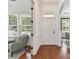 Bright foyer with hardwood floors, white door, and an adjacent sitting room with large windows at 4732 Water Oak Rd, Charlotte, NC 28211