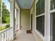 Covered front porch showcasing white columns, blue ceiling, and a view of the neighborhood street at 4732 Water Oak Rd, Charlotte, NC 28211