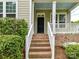 Inviting front porch with brick steps, white railings, and a black front door, with house number 4732 at 4732 Water Oak Rd, Charlotte, NC 28211