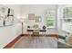Bright home office featuring hardwood floors, a modern desk, and natural light from a large window at 4732 Water Oak Rd, Charlotte, NC 28211