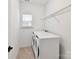 Bright laundry room featuring a washer and dryer hookups, enhanced by a window and shelving at 4732 Water Oak Rd, Charlotte, NC 28211