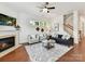 Bright living room with a fireplace, hardwood floors, lots of natural light, and a staircase in view at 4732 Water Oak Rd, Charlotte, NC 28211