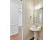 Charming powder room showcasing a pedestal sink, decorative mirror, and elegant lighting at 4732 Water Oak Rd, Charlotte, NC 28211