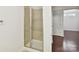 Modern shower with glass doors and tile surround, adjacent to an open bedroom, creates a spa-like retreat at 4732 Water Oak Rd, Charlotte, NC 28211