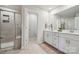 Bathroom featuring double sinks, vanity, shower, and a separate toilet room at 500 Cedar Knoll Cir, Pineville, NC 28134