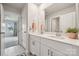 Bright bathroom with double vanity, neutral cabinets and countertops, complemented by a decorative mirror and plant at 500 Cedar Knoll Cir, Pineville, NC 28134