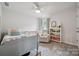 Bright bedroom with a bed, crib, chair, and bookshelf; adorned with natural light and soft colors for a cozy feel at 500 Cedar Knoll Cir, Pineville, NC 28134