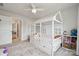 Charming bedroom featuring unique house-frame bed, playful decor, and soft, patterned carpet for a cozy, imaginative space at 500 Cedar Knoll Cir, Pineville, NC 28134