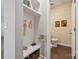 Inviting entryway with coat hooks, bench, and access to the powder room at 500 Cedar Knoll Cir, Pineville, NC 28134