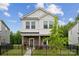 Charming two-story home with stone accents, black fence, and manicured lawn at 500 Cedar Knoll Cir, Pineville, NC 28134