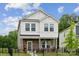 Charming two-story home featuring a stone-accented porch, landscaped front yard, and inviting curb appeal at 500 Cedar Knoll Cir, Pineville, NC 28134