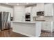 Modern kitchen featuring white cabinetry, stainless steel appliances, and a large island at 500 Cedar Knoll Cir, Pineville, NC 28134