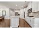 Stylish kitchen with stainless steel appliances, white cabinetry, and hardwood flooring at 500 Cedar Knoll Cir, Pineville, NC 28134