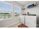 Well-lit laundry room featuring modern washer, dryer, and ample natural light, complemented by neutral-toned flooring at 500 Cedar Knoll Cir, Pineville, NC 28134