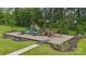 Vibrant playground with slides, climbing structures, and benches, set in a grassy area with mature trees, perfect for  at 500 Cedar Knoll Cir, Pineville, NC 28134