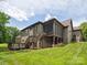 Exterior of house with a screened-in porch, open deck and grassy yard at 5805 Copperleaf Commons Ct, Charlotte, NC 28277