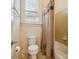 Bathroom with white toilet, curtained tub/shower, and small window at 5805 Copperleaf Commons Ct, Charlotte, NC 28277