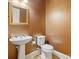 Powder room with pedestal sink and decorative gold mirror at 5805 Copperleaf Commons Ct, Charlotte, NC 28277