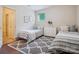 Charming bedroom with twin beds, patterned rug and natural light from the window at 5805 Copperleaf Commons Ct, Charlotte, NC 28277