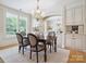 Bright dining room with chandelier and large window views at 5805 Copperleaf Commons Ct, Charlotte, NC 28277