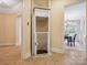Residential elevator between rooms with dining room in the background at 5805 Copperleaf Commons Ct, Charlotte, NC 28277