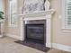 Close-up of the fireplace featuring a granite surround and custom mantel at 5805 Copperleaf Commons Ct, Charlotte, NC 28277