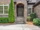Close up of stone accented entryway with a decorative wreath at 5805 Copperleaf Commons Ct, Charlotte, NC 28277
