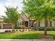 Charming stone home with manicured lawn and mature landscaping at 5805 Copperleaf Commons Ct, Charlotte, NC 28277