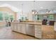 Open concept kitchen with stainless steel appliances and adjacent dining and living spaces at 5805 Copperleaf Commons Ct, Charlotte, NC 28277