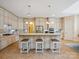 Gourmet kitchen featuring custom cabinets, granite countertops and island at 5805 Copperleaf Commons Ct, Charlotte, NC 28277